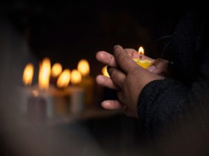 A close-up of a person holding a candle next to a row of candles. Grief counseling in Grand Rapids, MI can offer support from the support of home. Learn more about online grief counseling in Kent County, MI by contacting a grief counselor in Grand Rapids, MI today. We offer grieving counseling in Grand Rapids, MI and more. 