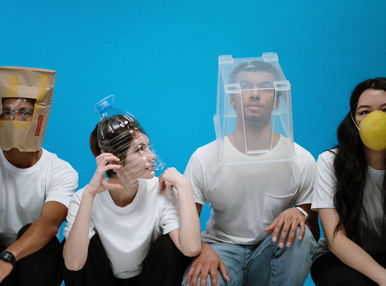 Four people sit next to eachother while wearing various covering over their faces. This could represent social anxiety after covid that an anxiety therapist in Grand Rapids, MI can address. Learn more about online anxiety treatment in Kent County, MI and more.